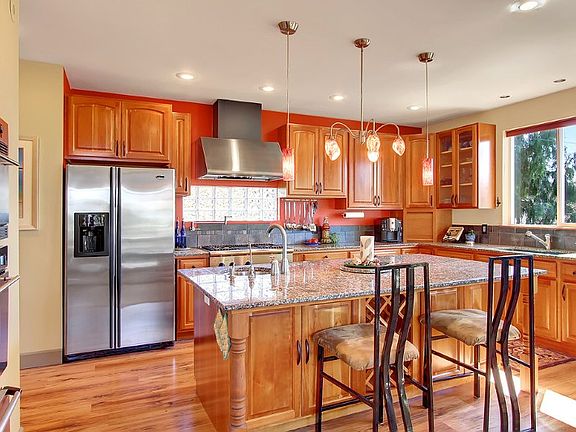 Entertain in style! Chef's kitchen with professional grade stainless appliances including Bosch dishwasher, cherry cabinets, granite slab counters, tile backsplash, 2 sinks, soup pot filler over the range, walk-in pantry and designer lighting. The glass block window brings in the natural light but keeps it private. Plenty of prep space for bringing out the Chef in you!