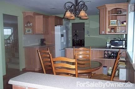 Kitchen : Hardwood Floor, exquisite cabinetry, corian counters, bay window.