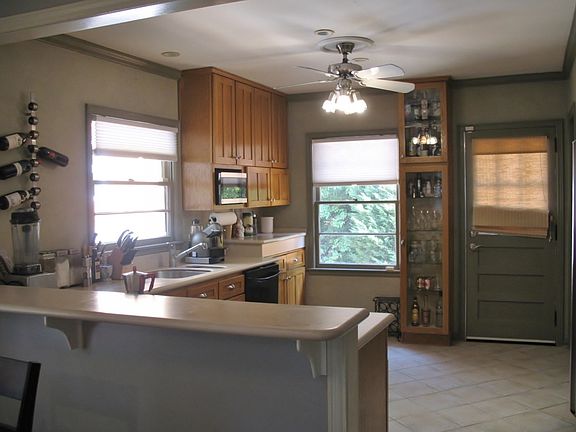 Large kitchen with maple cabinets, solid countertops and doo