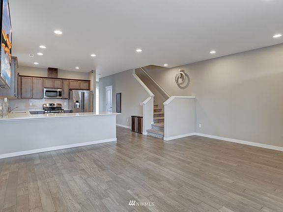 Glimpse into the kitchen; that door is a large pantry and additional storage under the stairs.