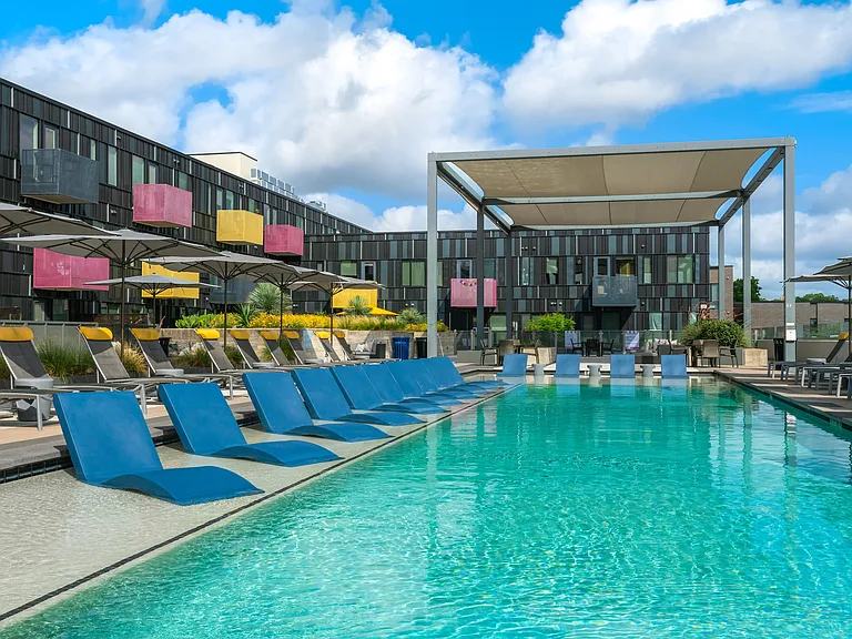 Outdoor Pool Area with Sun Loungers and Shaded Relaxation Zones