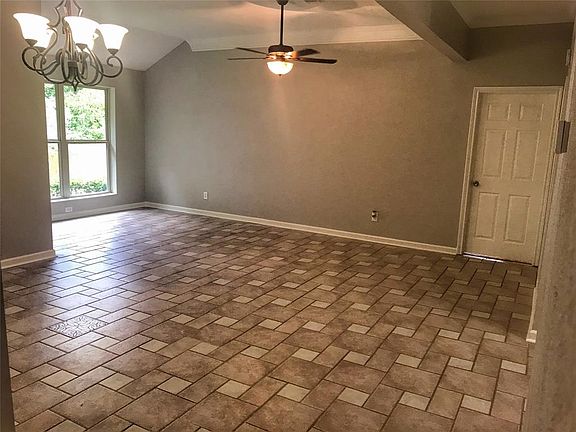 Large living room with crown molding
Door to Master bedroom seen on right
