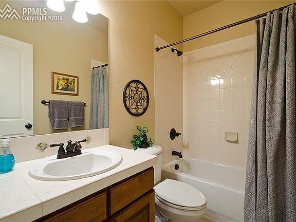 Full Hall Bathroom w/tile floor, single sink vanity & tiled tub/shower