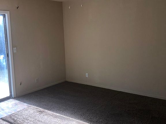Bedroom with sliding door access to patio.
