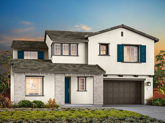 A two-story white house with a garage, surrounded by lush greenery and a vibrant sky in the backgrou