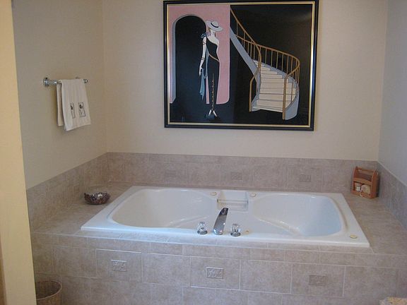 Remodeled master bath with jacuzzi tub, shower and double sinks.