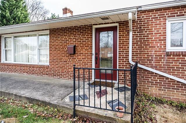 Wide concrete walkway to beautiful front door!