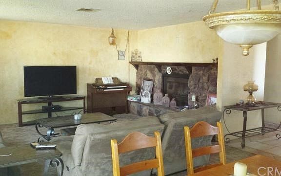 Family Room with Large Fireplace adjoined to Dining Area