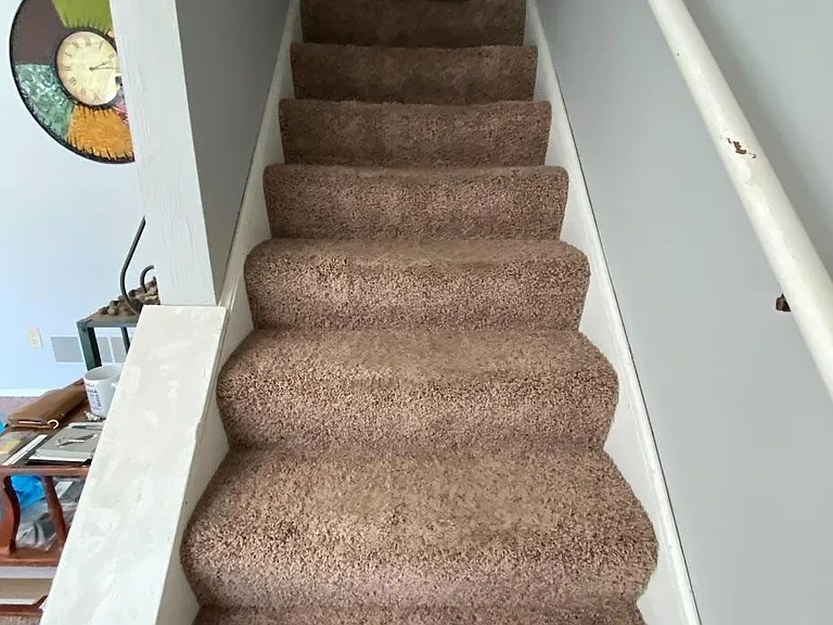 stairs to 2nd floor does not show carpet removed and stained wood stairs and new paint thru out house
