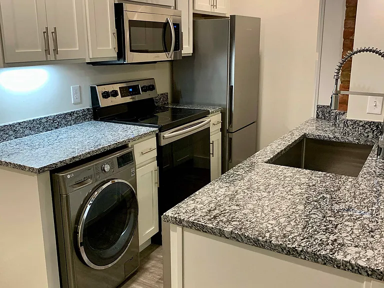 Kitchens feature stainless steel appliances and granite counter tops