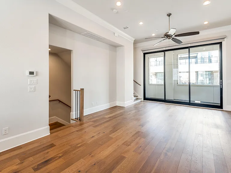 2nd floor living area features a 3-panel sliding glass door that opens up to the balcony.