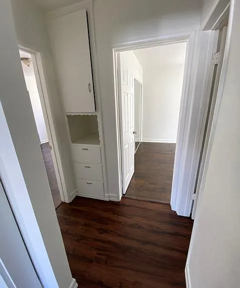 view from the hall way with bedroom 1 to your left, bathroom to the right, and bedroom 2 adjacent.