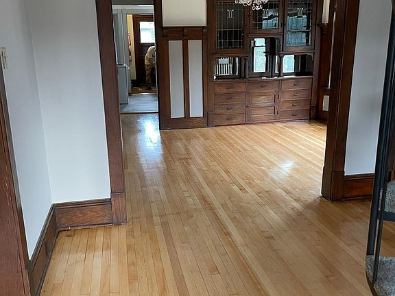 Entry into apartment. living room to left, dining room and kitchen ahead. Spiral staircase at right goes to loft space.