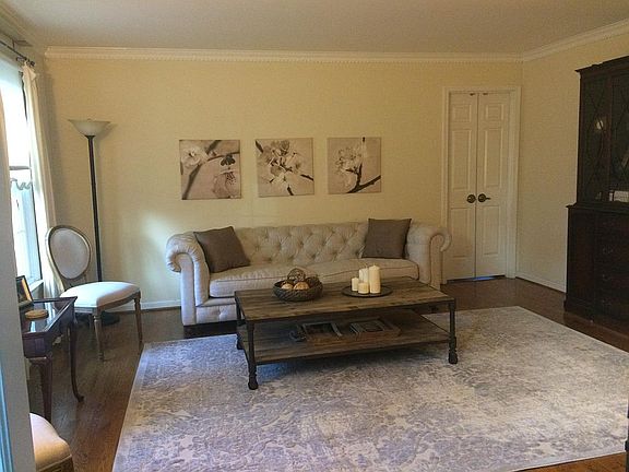 Living room. First room to the left when you walk into house from front foyer. Back doors are entry into office with four windows and second fireplace on main floor.
