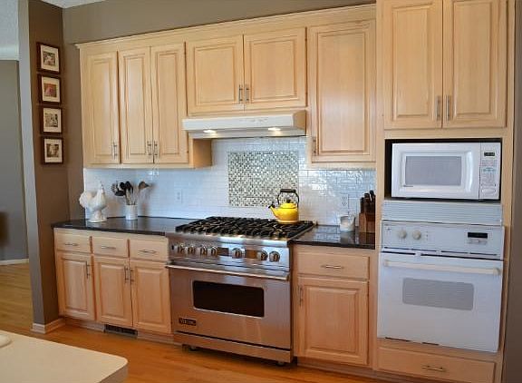 The BIG center island kitchen offers tons of raised panel maple cabinetry, a Viking range, new dishwasher, built-in ovens, new granite counter tops and maple floors.