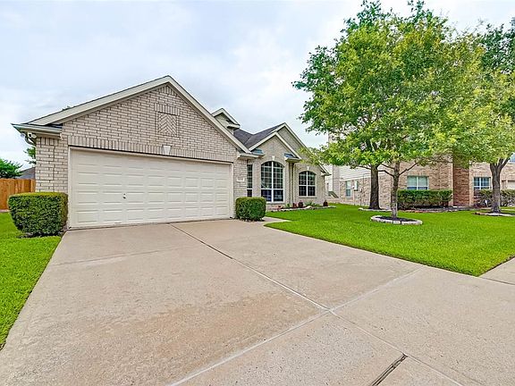 Mature trees and a tidy yard offers great curb appeal!
