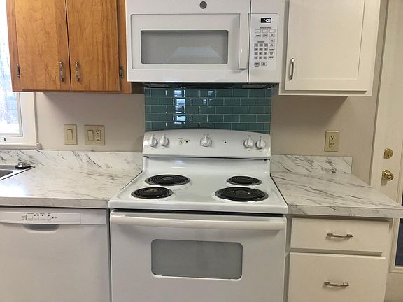 Kitchen stove. New microwave and new dishwasher. New counters.