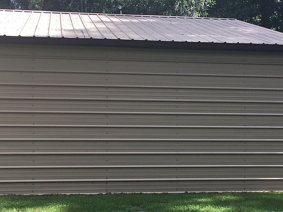 Metal building fits 3 cars.