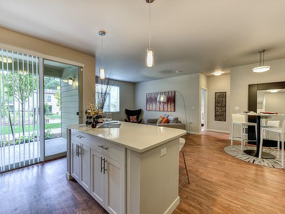 Kitchen Island with Dining Area and View of Private Patio