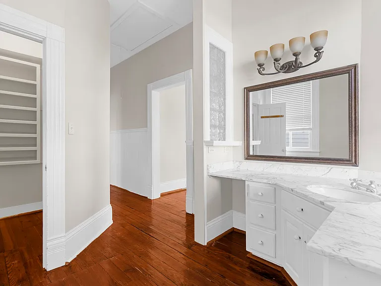 Vanity and Walk-In Closet at end of Hallway Before Master Bedroom