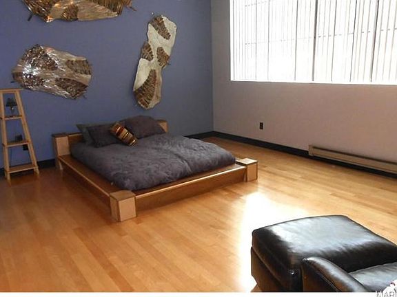 Huge master bedroom with wood floor, big window area.