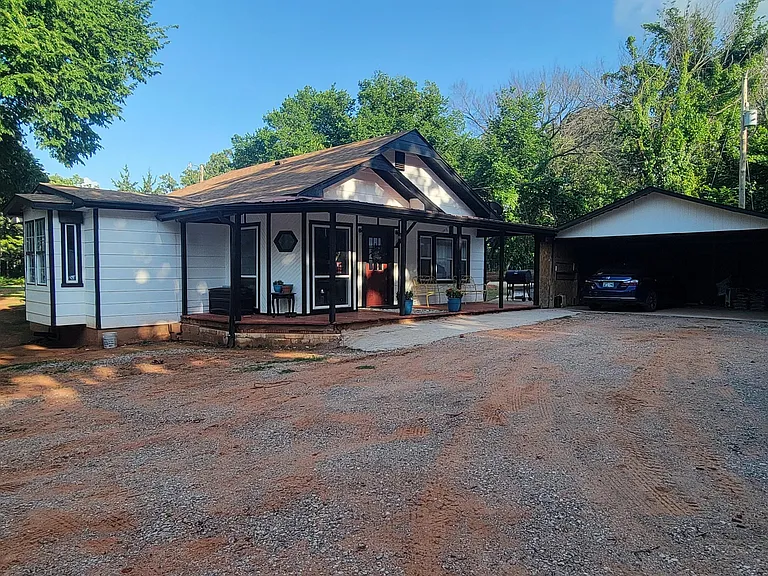 Front of the house with covered porch and 2 car car port