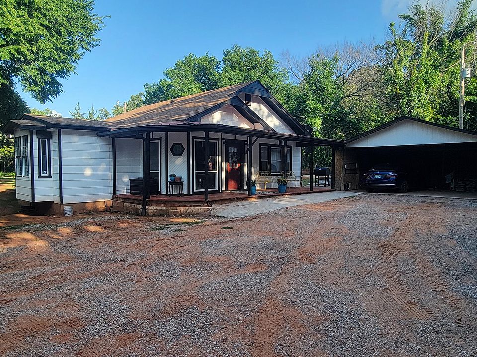 Front of the house with covered porch and 2 car car port