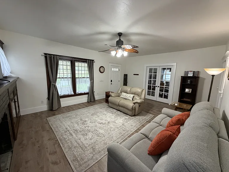 The family room features French doors leading into the dinning room and kitchen.