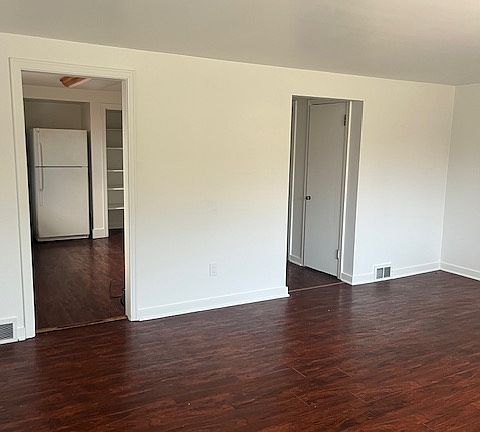 Main living area showing entry to kitchen and hallway to bedrooms
