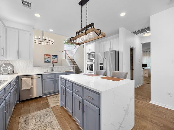 Gourmet Chef's Kitchen with Expansive Dining: A culinary haven featuring, all high-end stainless steel kitchen appliances, elegant and durable quartz kitchen countertops