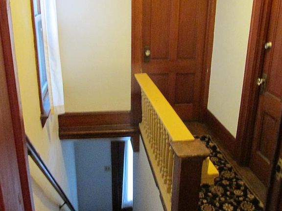 Front entry and stairs to hall and porch doors.