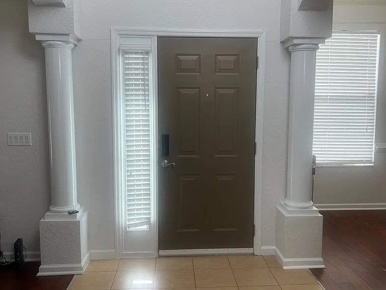 59 - Front entry with decorative columns and side light windows.