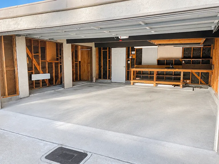 two car garage with workbench and storage