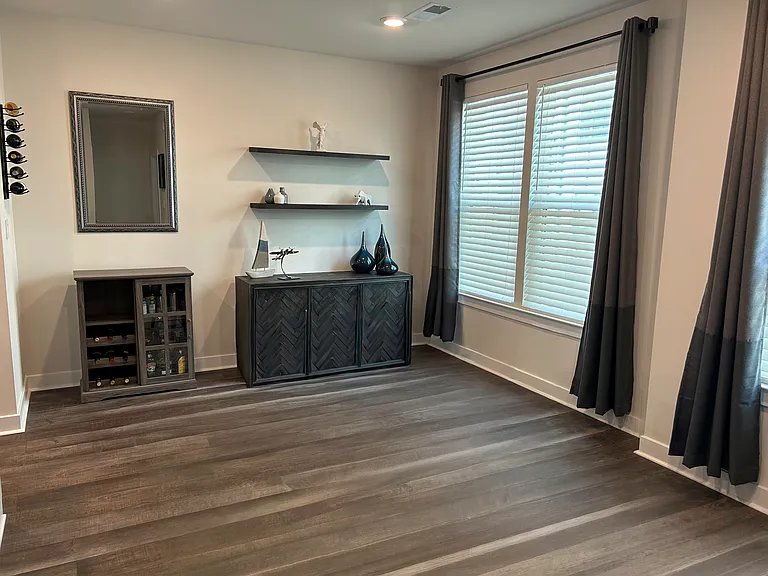 Dining room features floating shelves and a wine rack