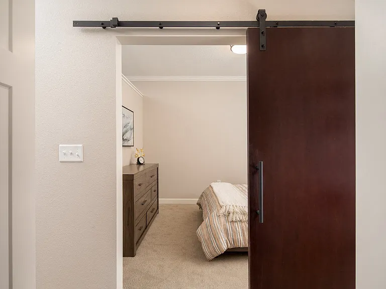 View of bedroom with modern sliding sliding door at The Whitley.