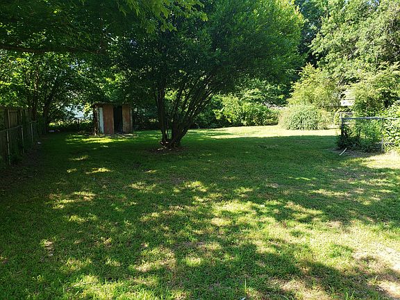 Large, mostly fenced backyard