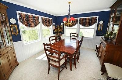 Formal dining room has wainscoting trim.