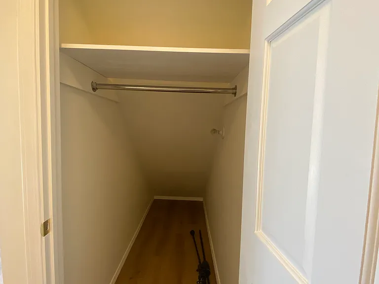 hall closet behind kitchen/living room