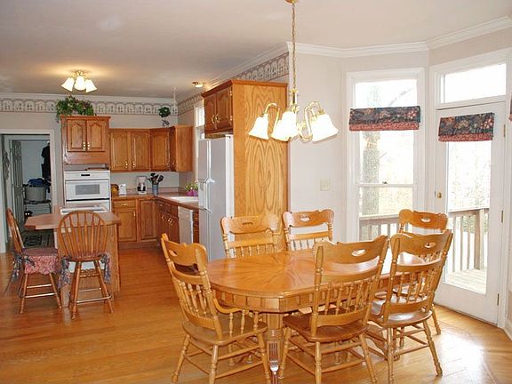 Kitchen has eat in area. Glass doors lead to deck.  