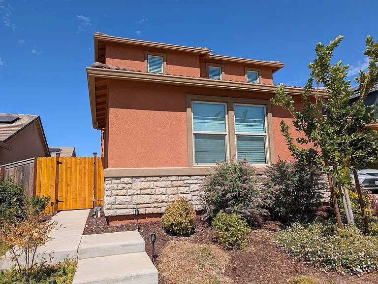Beautifully maintained exterior. A different perspective of this stunning property, emphasizing its solid construction and inviting presence within the community.