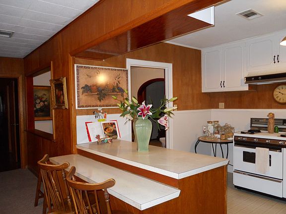 Kitchen breakfast bar opens into the den