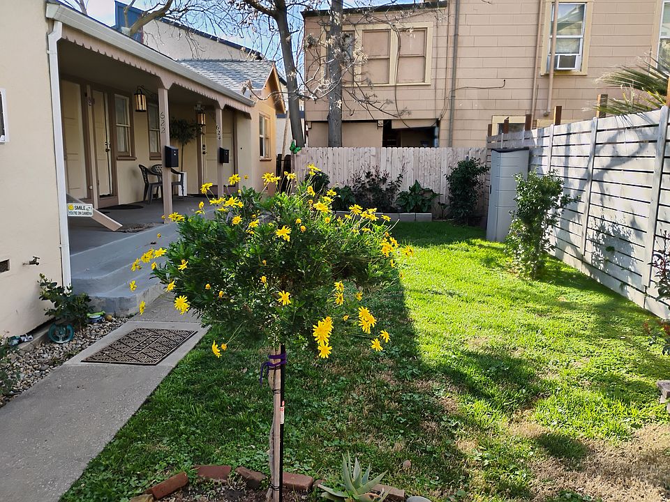 Available unit is on the left side of the duplex; Private yard area shown.