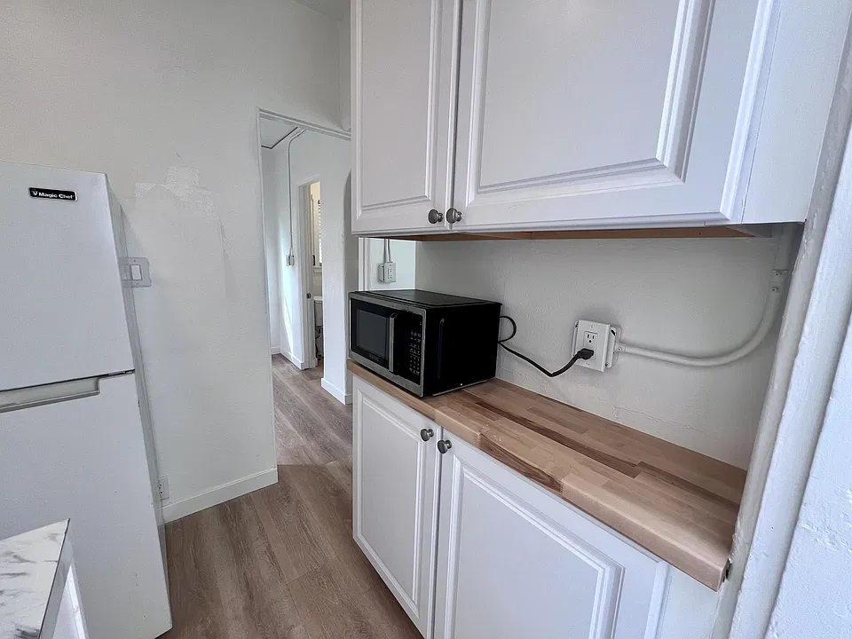 Newly remodeled Kitchen. New cabinets, butcher block countertop and microwave.
