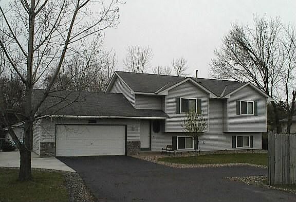 Driveway with turnaround and concrete pad on side.