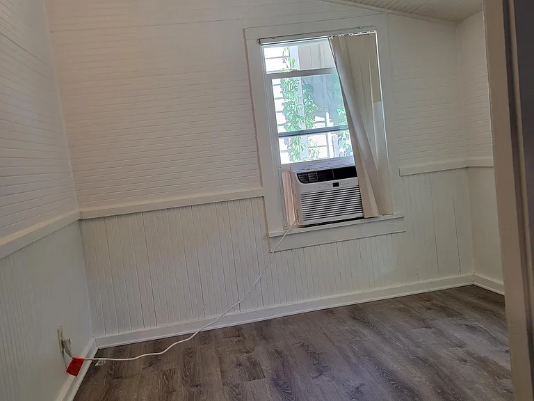 room off the kitchen with window air and heat. I used it as an office but it is versatile and could be a hobby room, etc