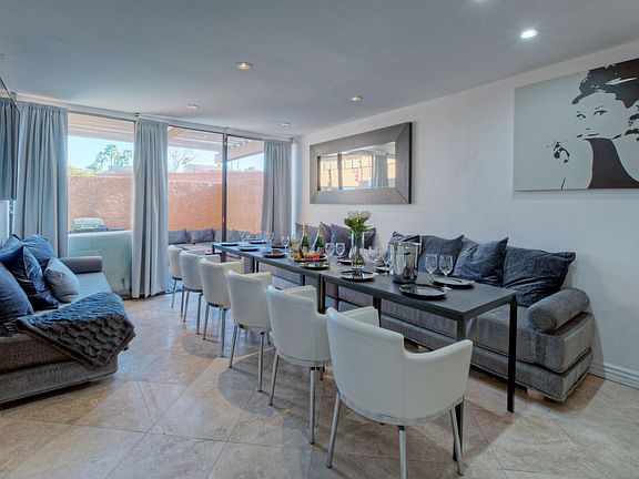 Entertaining Modern Living - Dining - Bar Lounge with long table for larger families/friends including a 70 inch 4k Smart TV next to the outdoor SPA patio.