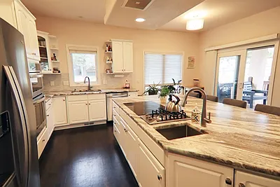 Another view of kitchen- toward deck exit door- 4 Burner induction stove and 2 burner gas stove