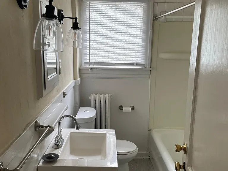 Completely Renovated Bath w/ New Wood Tile, New Vanity, Vanity Faucet, Sconces, Chair Height Dual Flush Toilet and Hardware.