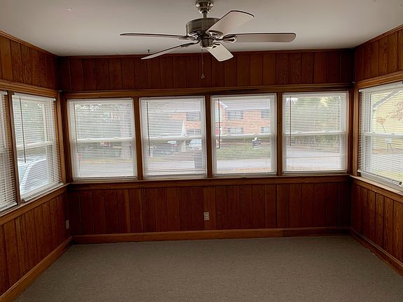 Kitchen/dining room areas open up to a lovely Sun Room with tons of new windows, natural light, quality wood paneling and exposed brick