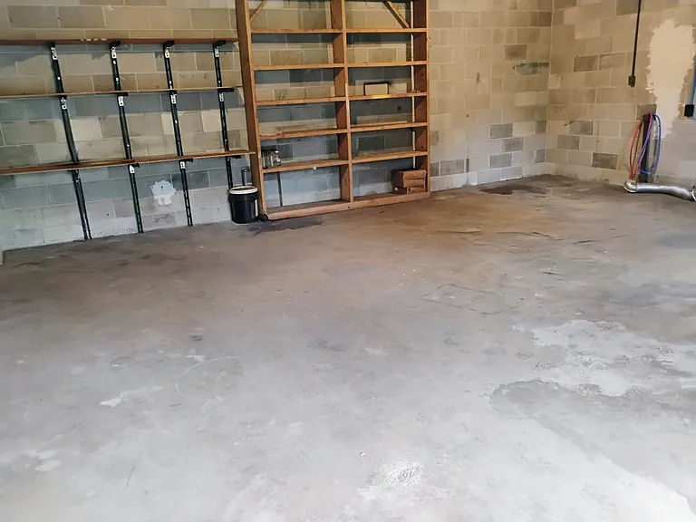Inside view of Garage. Washer / Dryer Connections & Shelving for convenience.